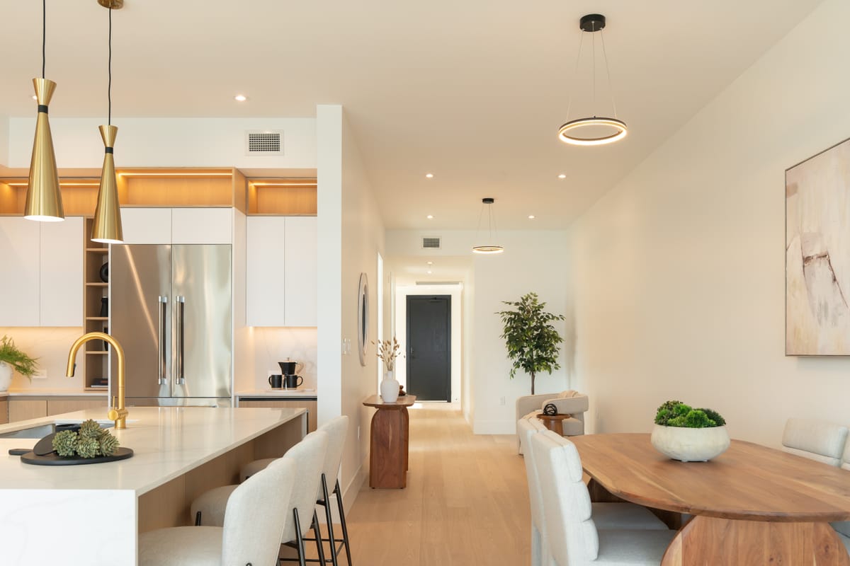 Quartz kitchen island with brass tap and three pendant lights