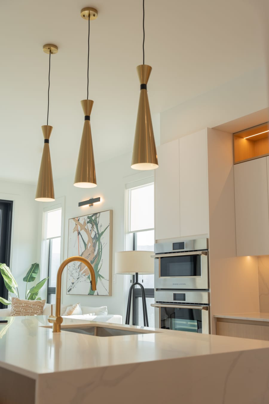Kitchen island with a brass tap and quartz counter